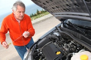 Senior Changing Oil in His Car